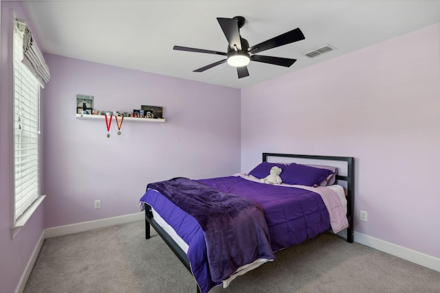 bedroom featuring ceiling fan and carpet