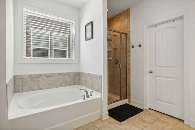 bathroom with tile patterned floors and plus walk in shower