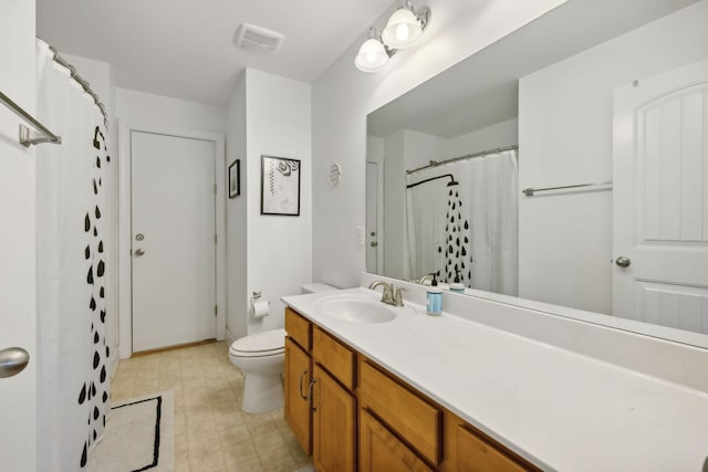 bathroom featuring vanity, toilet, and a shower with shower curtain