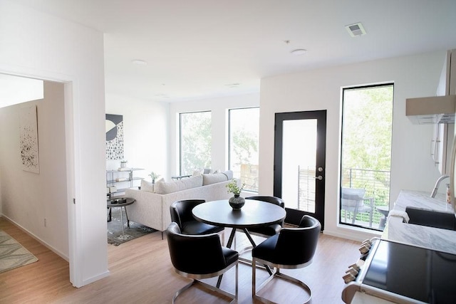 dining space featuring sink and light hardwood / wood-style flooring