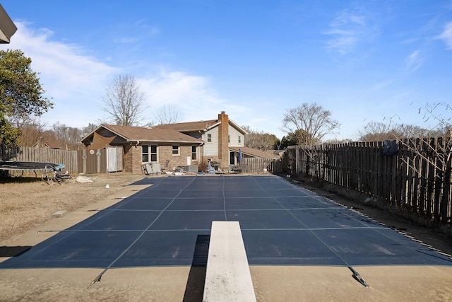 view of pool featuring a trampoline and a patio area