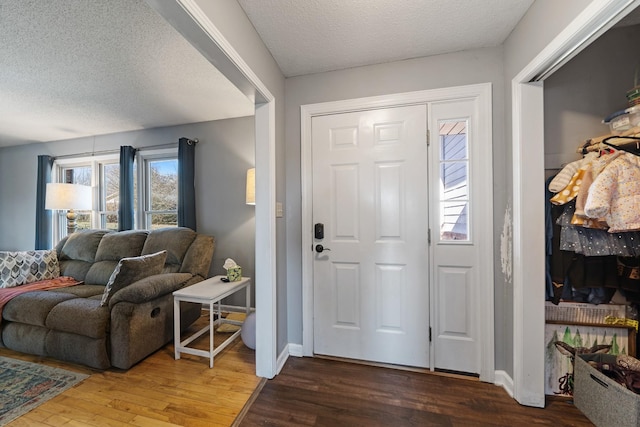 foyer featuring hardwood / wood-style flooring and a textured ceiling