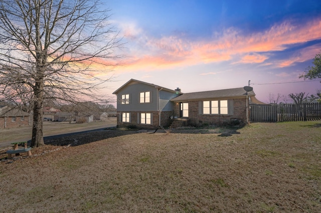 split level home with a lawn