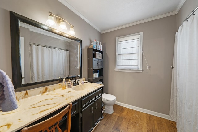 bathroom featuring hardwood / wood-style flooring, ornamental molding, vanity, and toilet