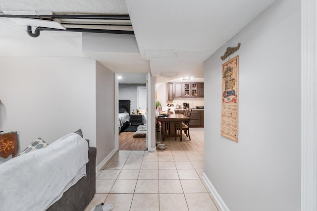 hall with light tile patterned floors