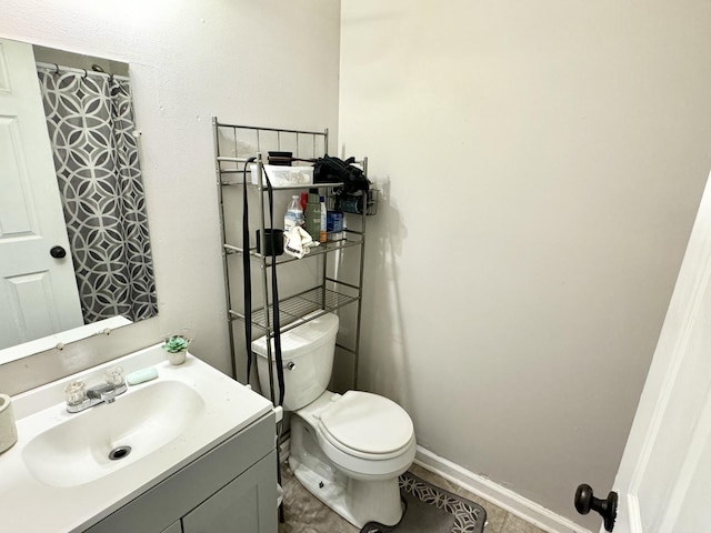 bathroom with vanity, toilet, and tile patterned flooring