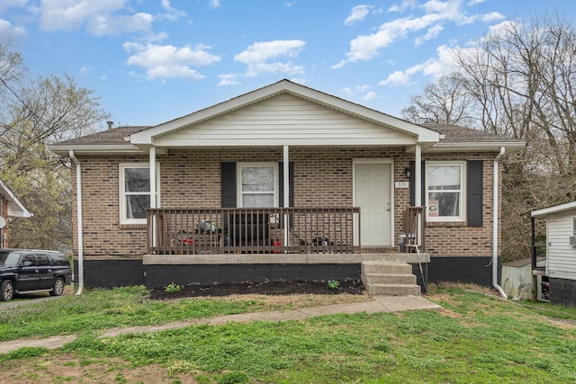 bungalow-style house with covered porch and a front lawn