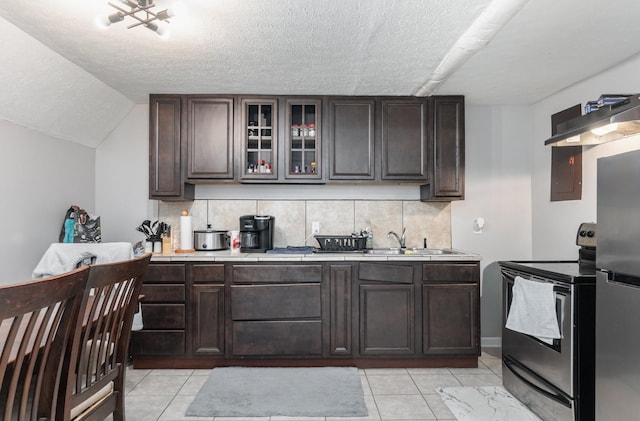 kitchen featuring sink, decorative backsplash, dark brown cabinets, and stainless steel appliances