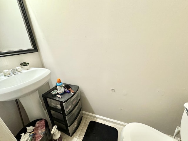 bathroom with tile patterned floors, toilet, and sink