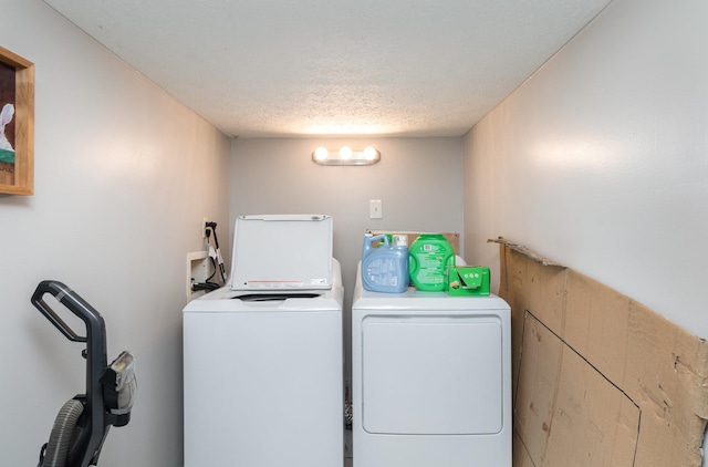 washroom featuring separate washer and dryer and a textured ceiling