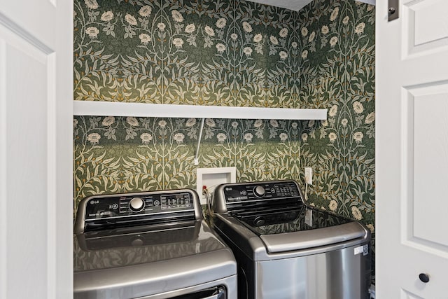 clothes washing area with separate washer and dryer