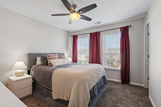 carpeted bedroom featuring a textured ceiling and ceiling fan