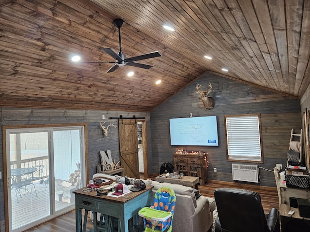 living room featuring lofted ceiling, hardwood / wood-style floors, wooden walls, wooden ceiling, and a barn door