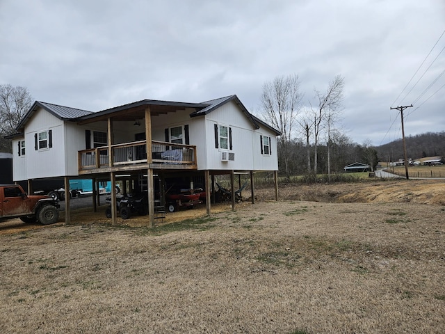 rear view of house featuring cooling unit and a deck