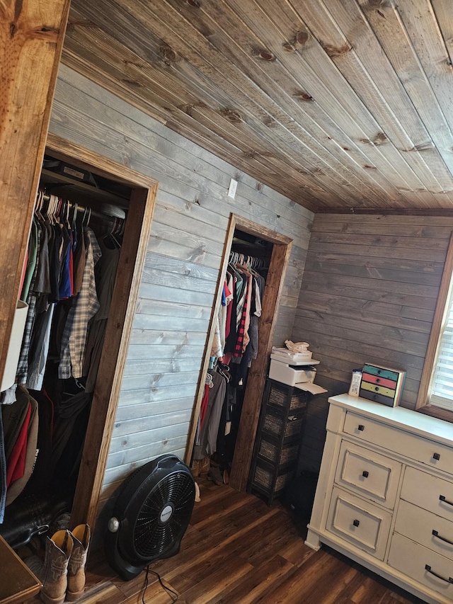 bedroom with wood ceiling, wooden walls, and a closet