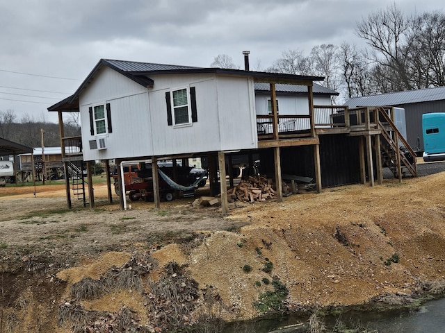 back of house featuring a wooden deck