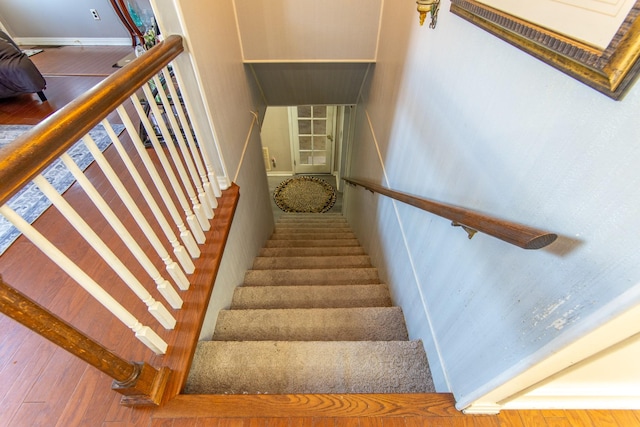 stairs featuring hardwood / wood-style floors