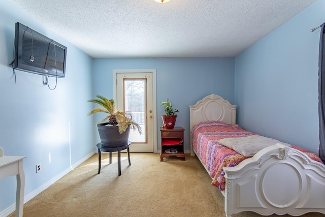 carpeted bedroom featuring a textured ceiling