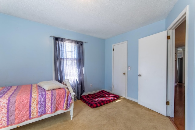 carpeted bedroom with a textured ceiling