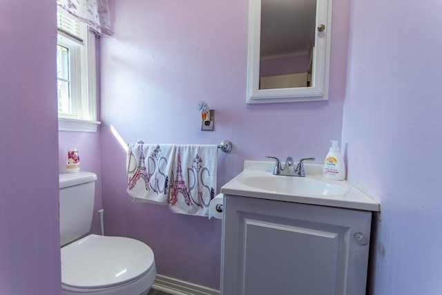 bathroom featuring vanity and toilet