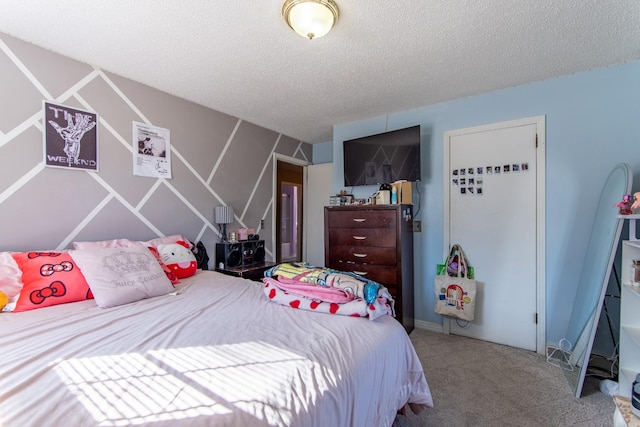 bedroom featuring carpet flooring and a textured ceiling