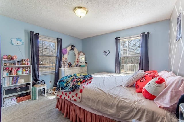 bedroom featuring carpet floors and a textured ceiling