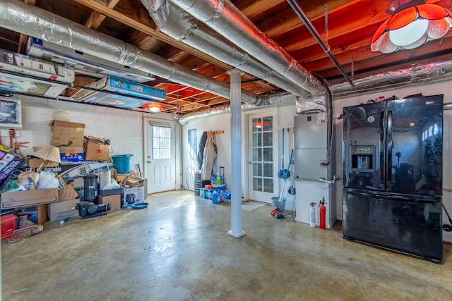 basement with black fridge with ice dispenser