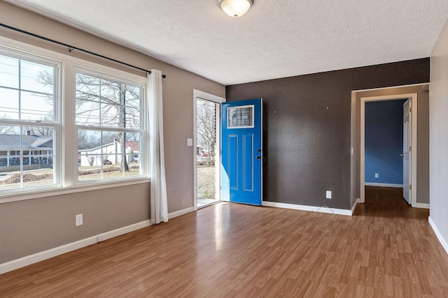 foyer entrance with wood-type flooring and a textured ceiling