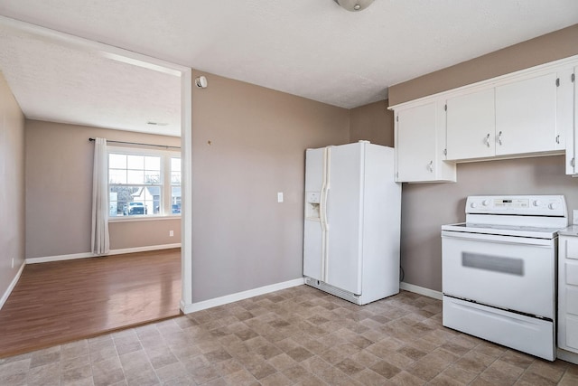 kitchen featuring white cabinets and white appliances