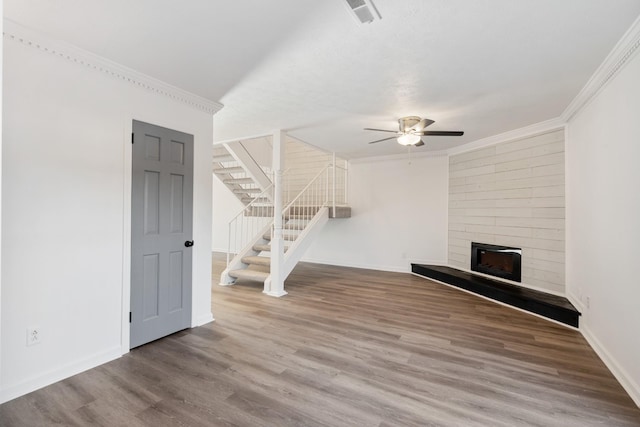 unfurnished living room featuring crown molding, wood-type flooring, and ceiling fan