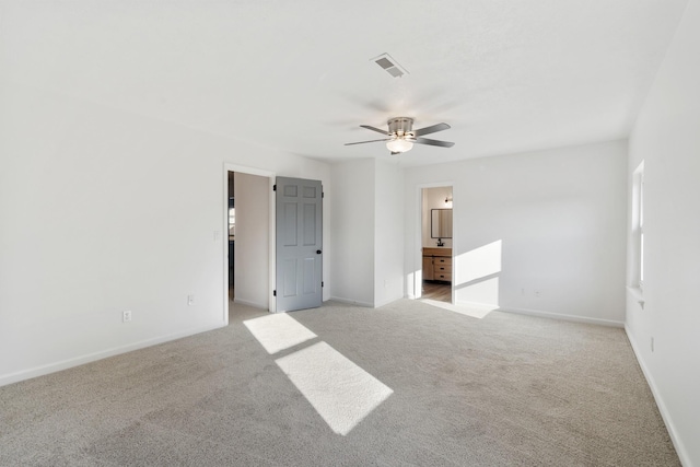 carpeted empty room featuring ceiling fan