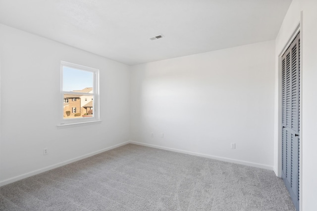 unfurnished bedroom with carpet floors and a closet