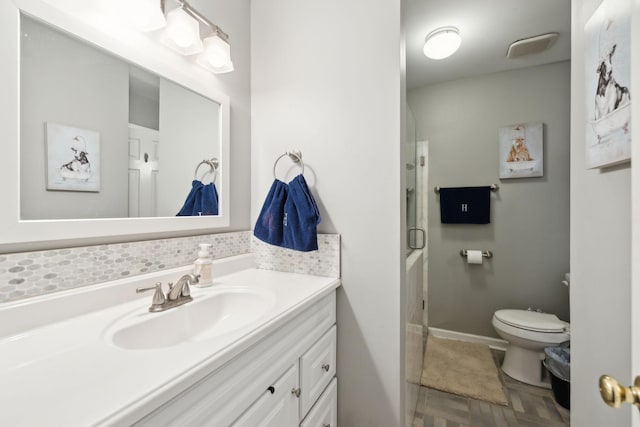 bathroom with vanity, parquet floors, and toilet