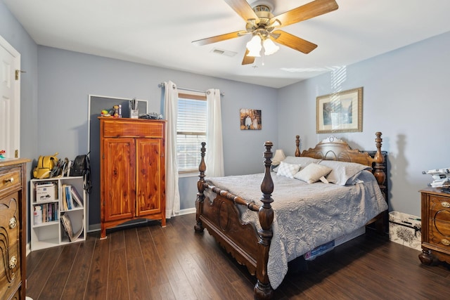 bedroom with dark hardwood / wood-style flooring and ceiling fan