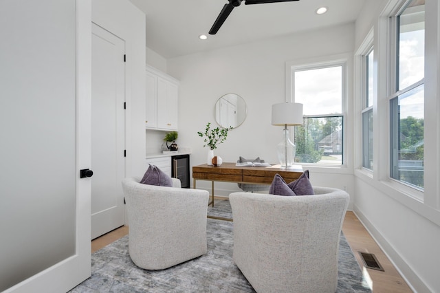 office area with light hardwood / wood-style floors and ceiling fan