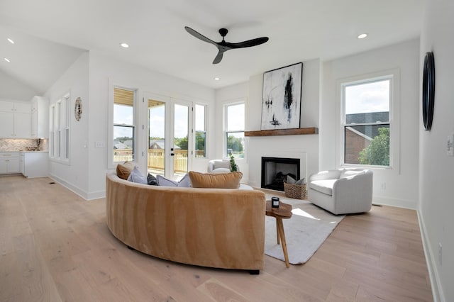 living room featuring french doors, ceiling fan, and light wood-type flooring