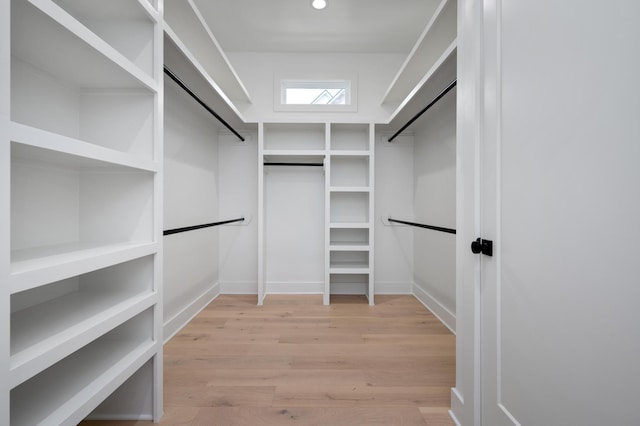 spacious closet with light hardwood / wood-style flooring