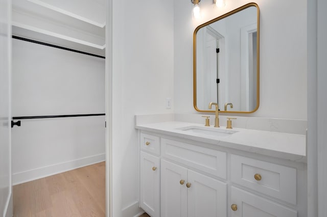bathroom featuring hardwood / wood-style flooring and vanity