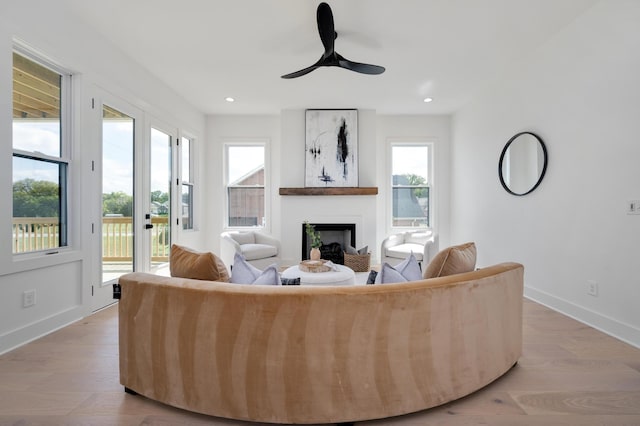 living room featuring ceiling fan and light hardwood / wood-style floors