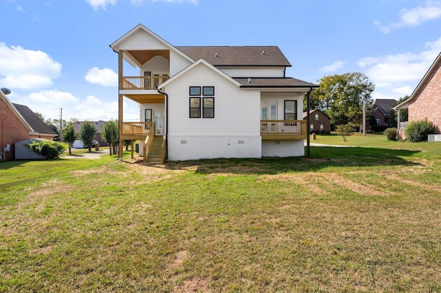 back of property with a lawn and a balcony