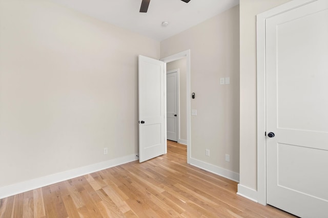 spare room with ceiling fan and light wood-type flooring