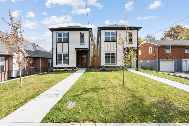 view of front of house featuring a garage and a front lawn