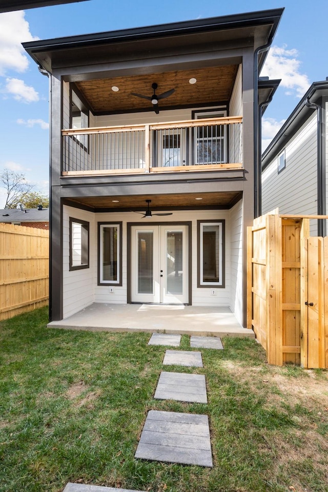 rear view of property featuring a patio, a balcony, and ceiling fan