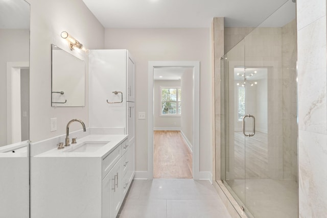 bathroom with tile patterned flooring, vanity, and a shower with shower door