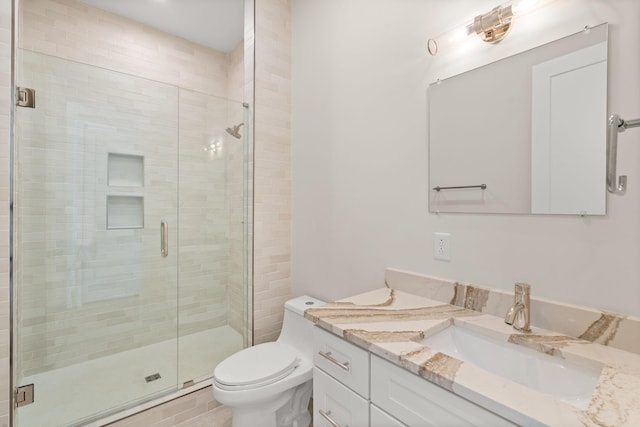 bathroom with vanity, toilet, and walk in shower