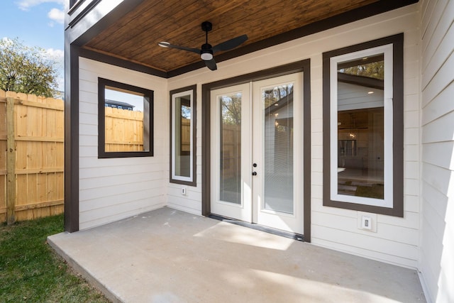 view of exterior entry featuring a patio area and ceiling fan