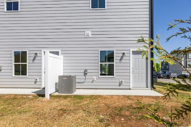 rear view of property featuring central AC unit