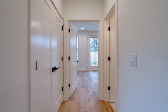 corridor with light hardwood / wood-style flooring