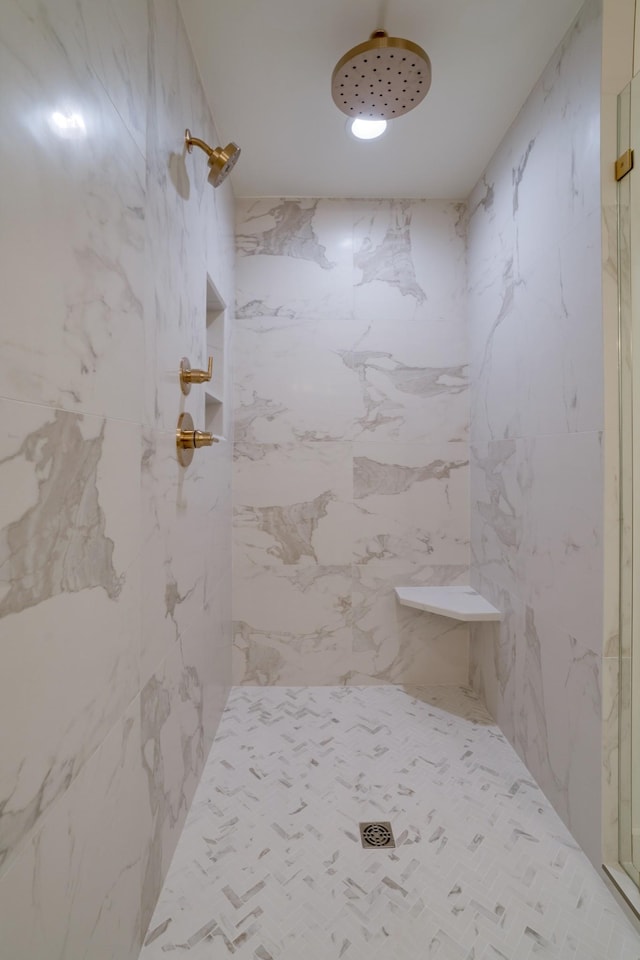 bathroom with tiled shower