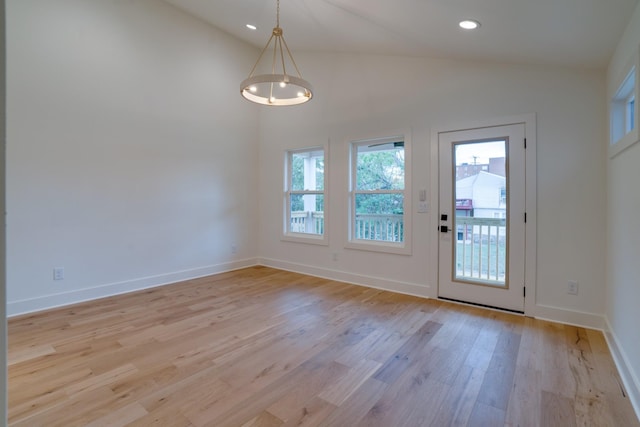 entryway with lofted ceiling, light hardwood / wood-style floors, and plenty of natural light